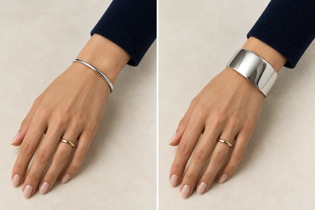 The same hand with a gold ring beside a narrow silver bracelet and a wider silver cuff.